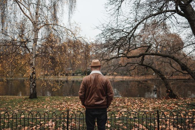 Anonymous man standing near pond