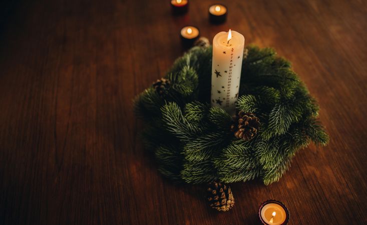 Christmas holiday decorations  of wreath and candles on table