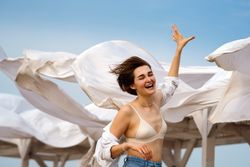 Woman on beach on windy day
