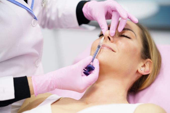 Woman having the tip of her nose injected