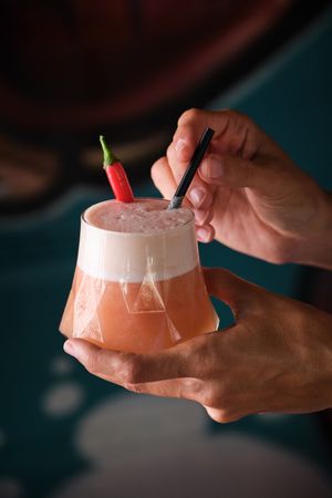 Faceless person with drinking cocktail
