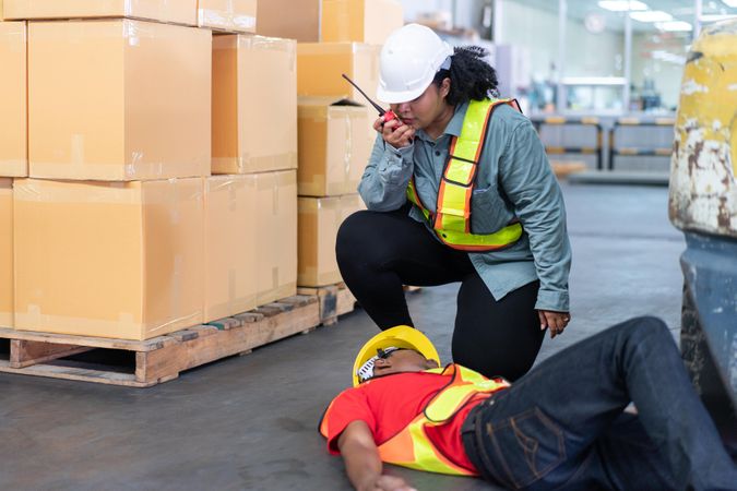 Black male in PPE gear passed out on distribution center floor