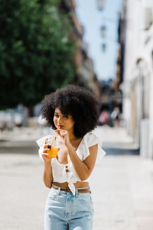 Young female enjoying refreshing drink