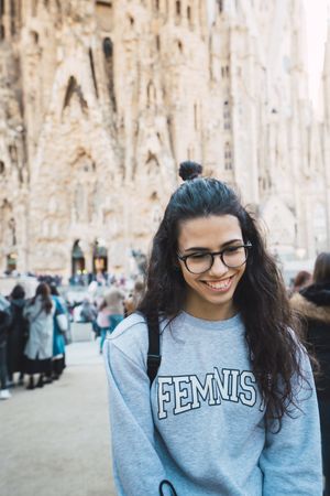 Smiling female tourist on city street