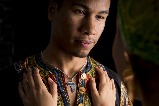 Black man smiling looking to hugging woman