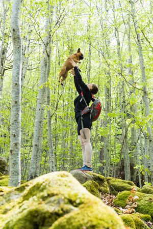 Traveling woman with dog in forest