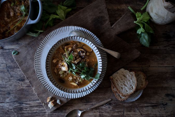 Bread and parsley near quinoa soup