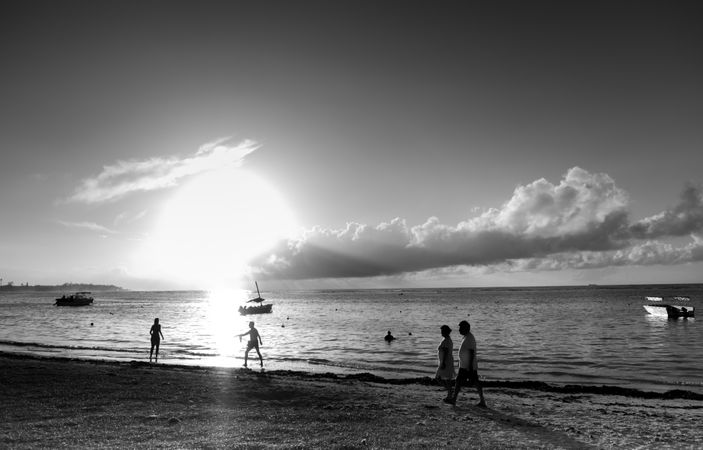 Silhouettes of people on beach in Indian Ocean