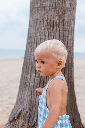 Portrait of a blonde baby boy on the beach