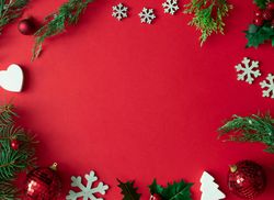 Red Christmas background with winter decoration, tree branches and leaves