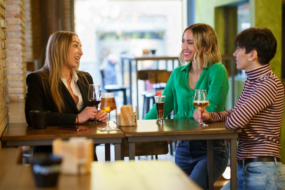 Female friends chatting in bar after work