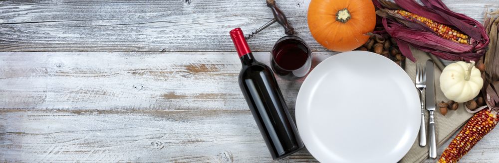 Dinner table decorated for Thanksgiving dinner celebration with plenty of copy space