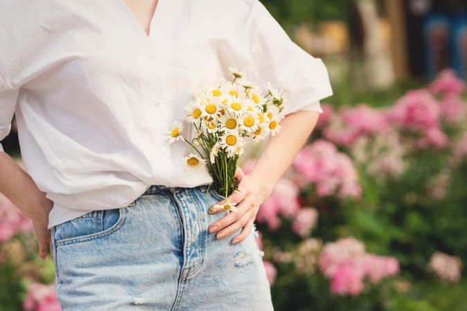 Woman with a bouquet of chrysanthemums. Background flowers