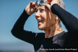 Mature woman taking off her swimming goggles after a swim 41dGZ5