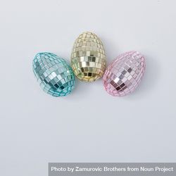 Disco ball Easter eggs in pink, blue and golden pastel colors bDlprb