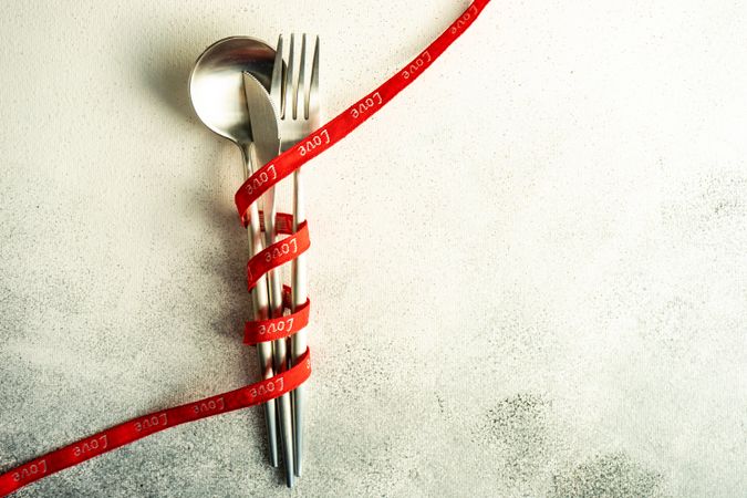 Silverware wrapped in red ribbon