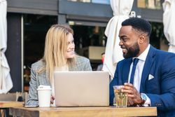 Business man and woman in a meeting in an outdoor cafe