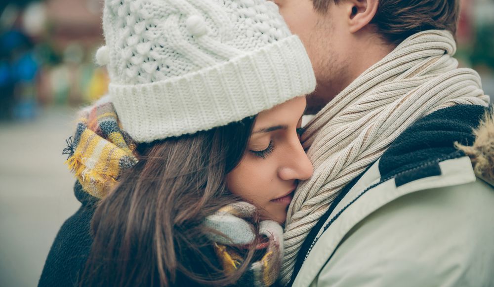 Cute couple embracing on an autumn rainy day