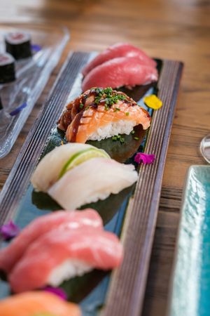 Row of nigiri sushi with raw fish