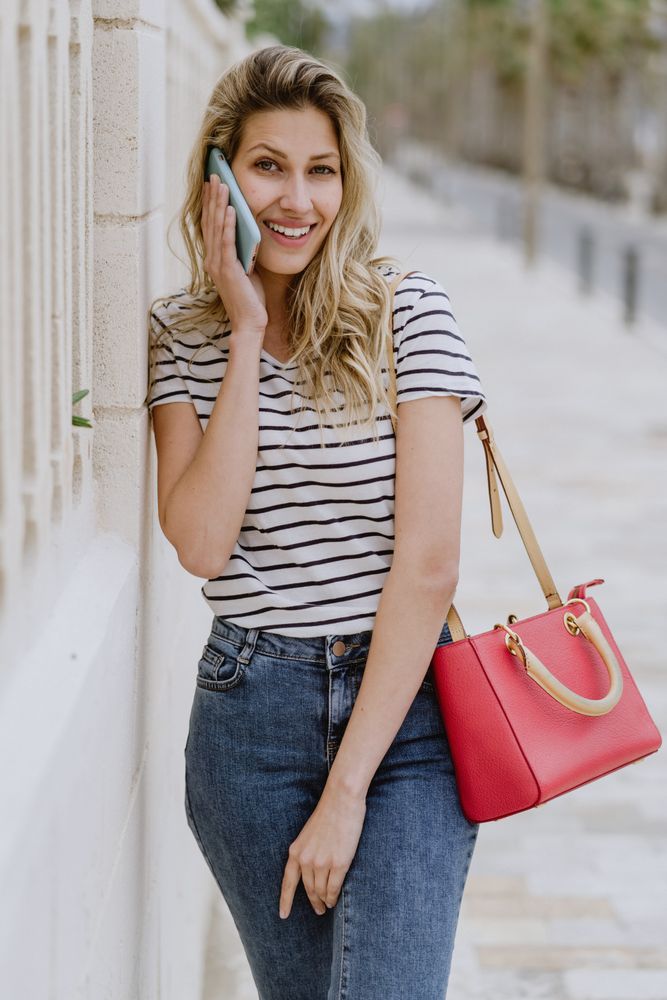 Woman using phone on city street