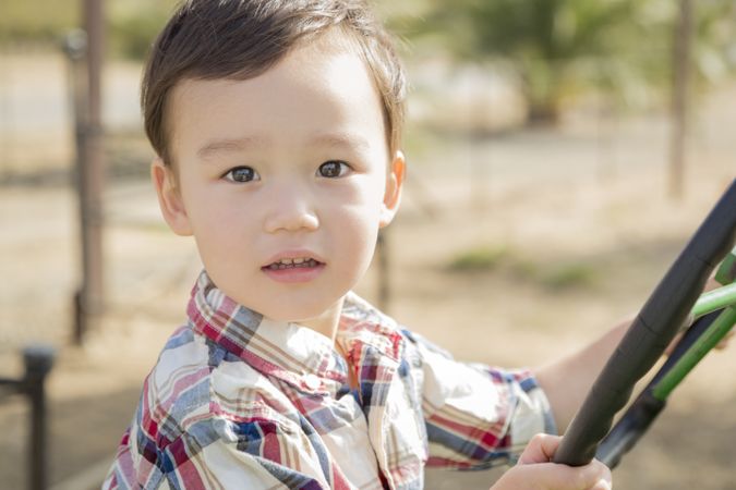 Young Boy Playing on Tractor