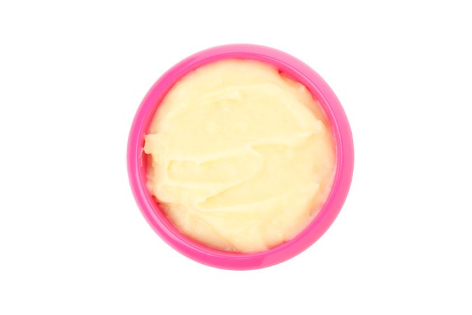 Bowl with healthy baby food isolated on plain background