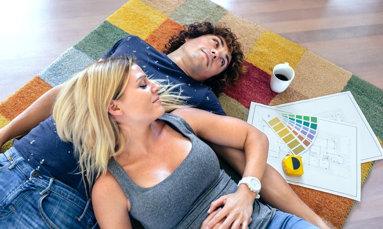 Couple resting lying on the carpet