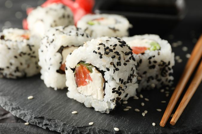Tray with delicious sushi rolls, close up. Japanese food