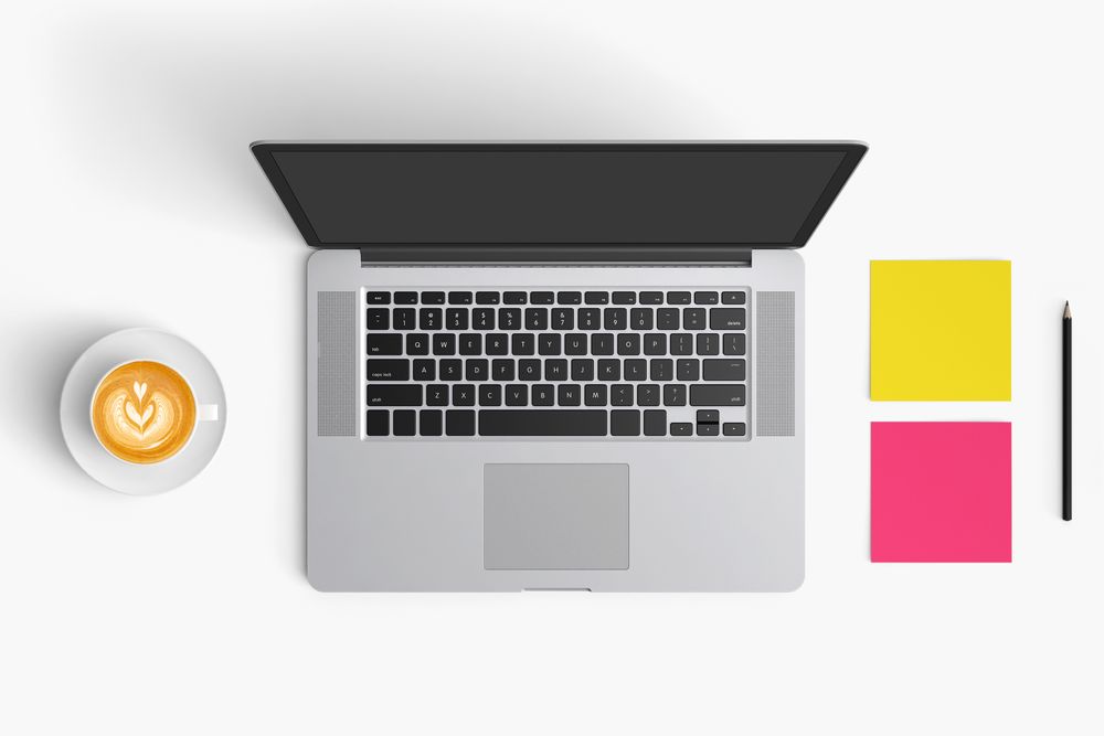 Modern workspace with coffee cup, smartphone, paper, notebook, tablet and laptop copy space