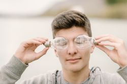 Young teenager with light bulbs on eyes