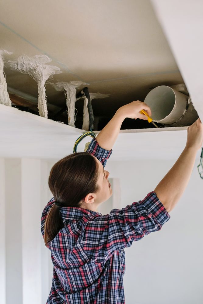 Woman placing tube for kitchen hood installation