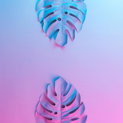 Tropical leaves in vibrant bold gradient blue and pink holographic neon colors