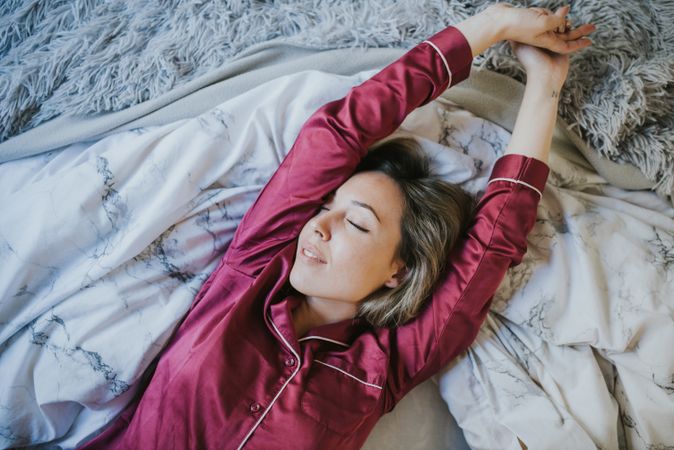 Woman sleeping and smiling in bed
