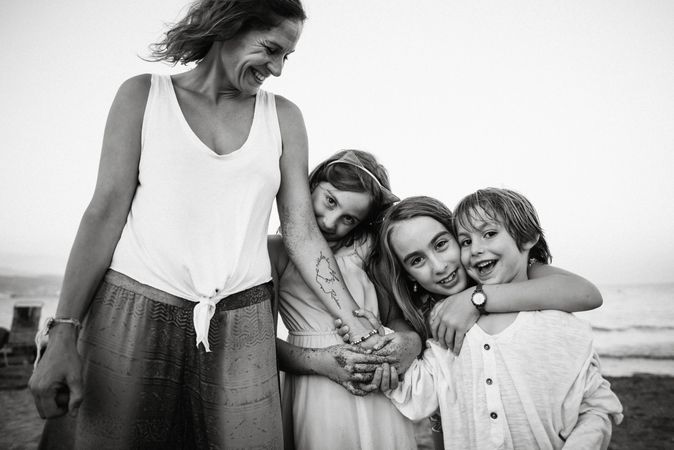 Woman with kids on seashore