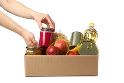 Woman folds products in donation box, isolated on plain background