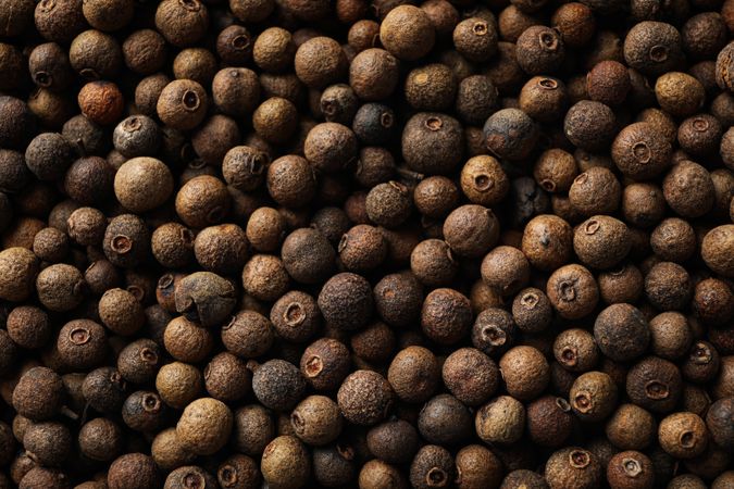 Close up top view of dark peppercorns