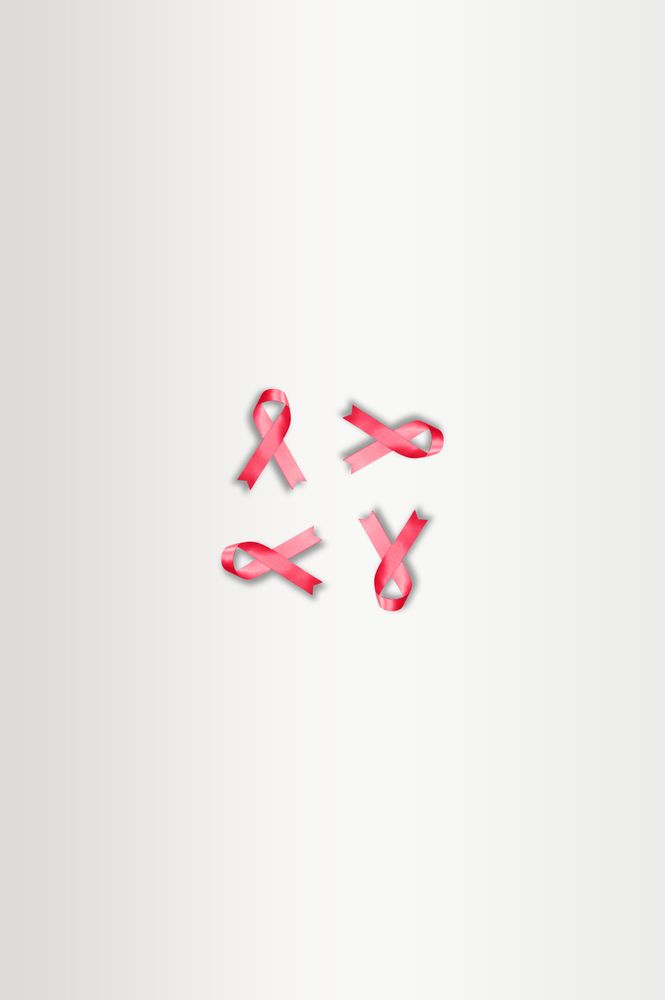 Four pink ribbons on plain background