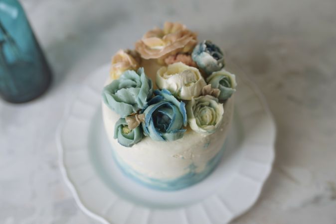 Buttercream flowers cake, blue and pastel peach colors
