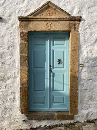 Patmian blue door with winged leg knocker