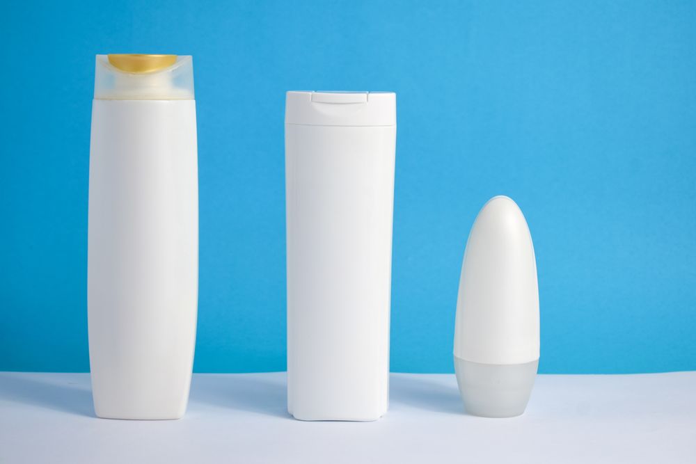 Three cosmetic bottles in blue room