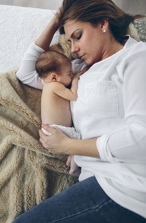Mother hugging her newborn baby girl