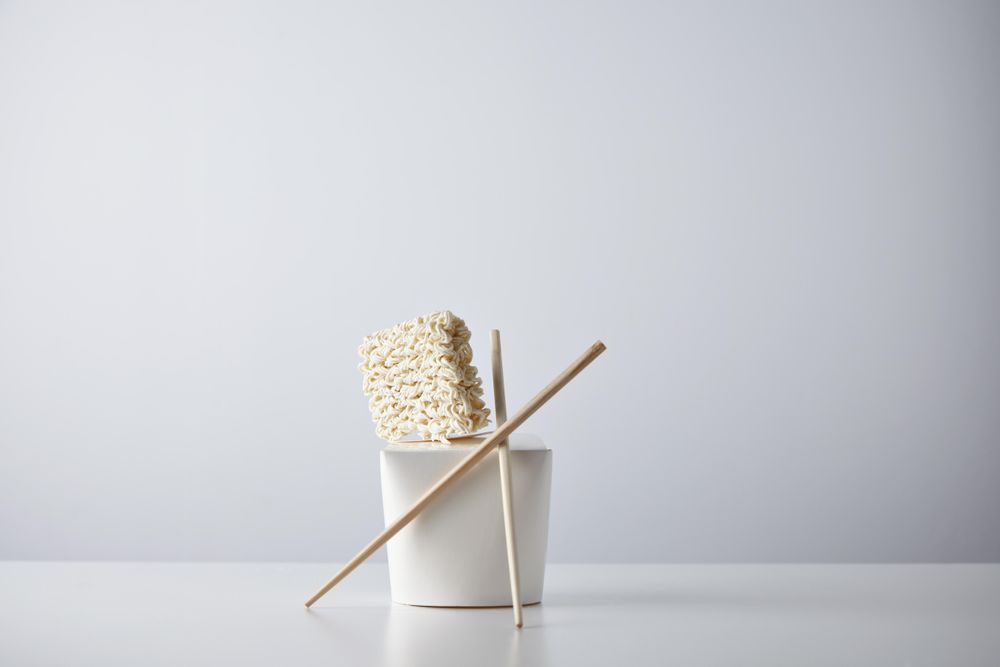 Dry noodles, chopsticks and take away container