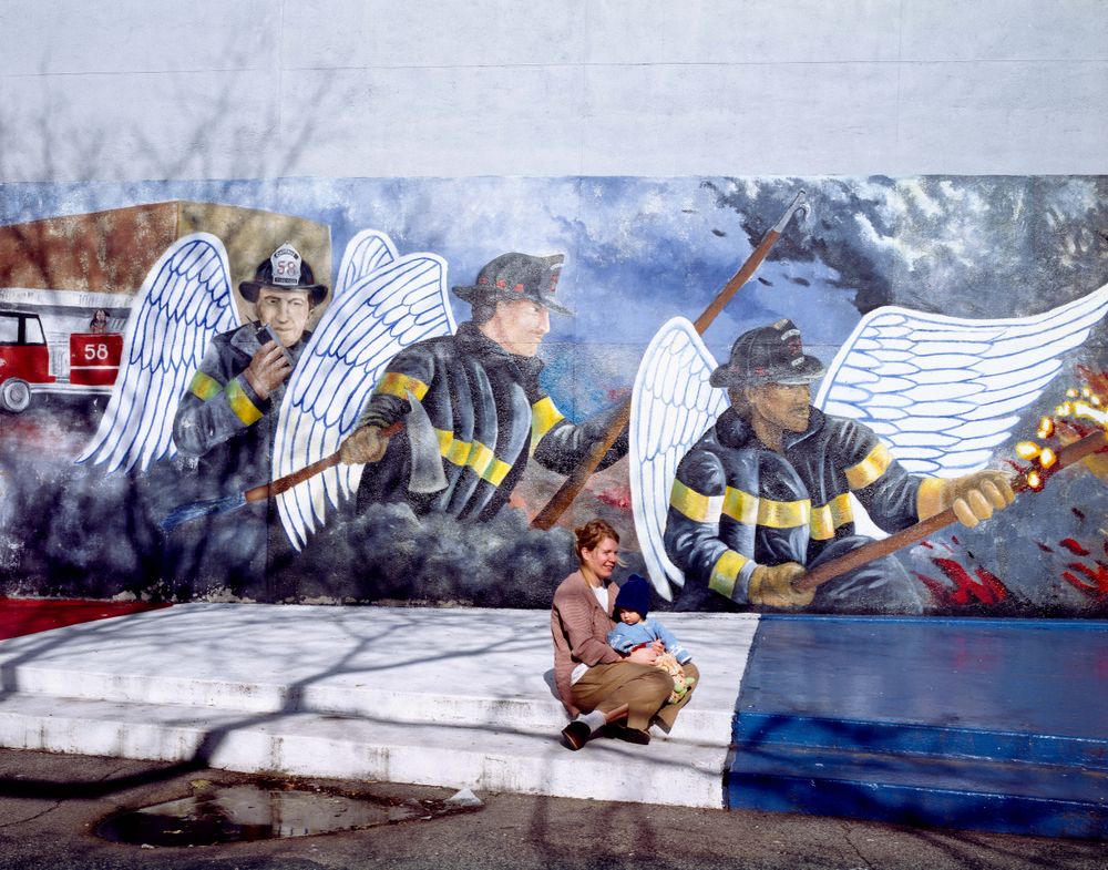 Mother and child in front of a Chicago Firefighter Mural