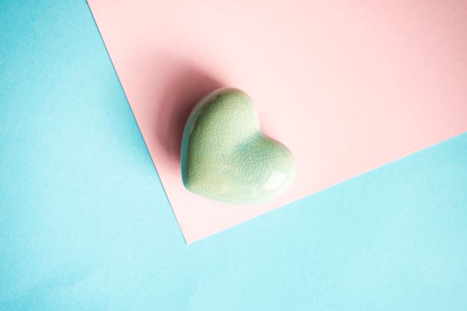 Green heart ornaments on pastel table 