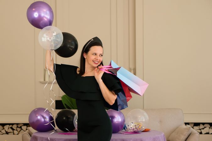 Woman in dress holding gift bag