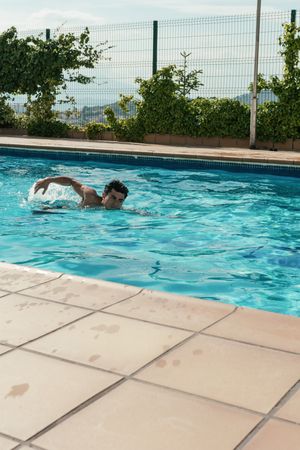 Asian boy swimming in the pool