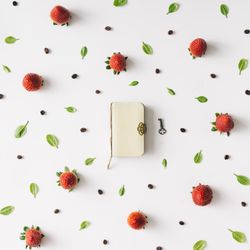 Pattern with strawberry, leaves and notebook