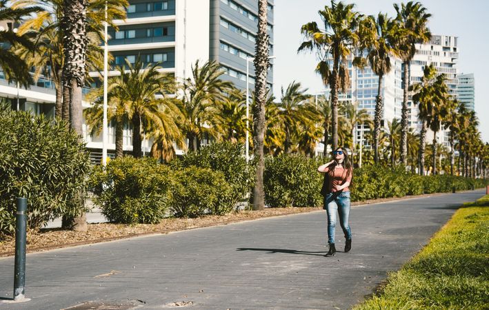 Woman walking on boulevard