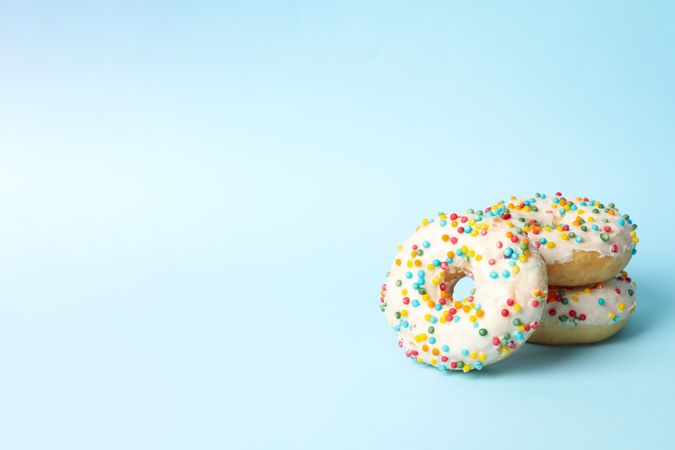 Tasty donuts on two tone background, space for text