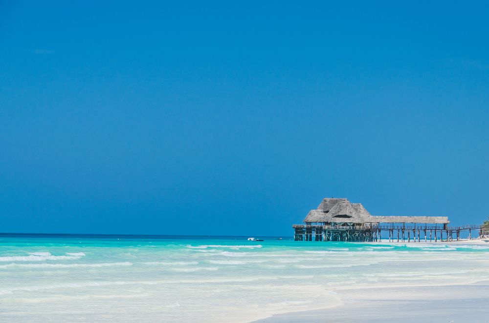 Tropical pier above a clear beach